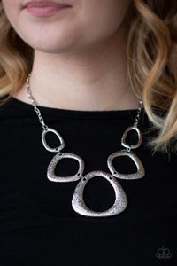 Hammered in a high-sheen finish, asymmetrical silver frames link below the collar in an edgy statement-making fashion. Features an adjustable clasp closure.  Sold as one individual necklace. Includes one pair of matching earrings.  Always nickel and lead free.