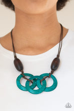 Load image into Gallery viewer, Infused with dramatic brown wooden beads, vivacious blue wooden hoops are knotted in place below the collar for a summery flair. Features an adjustable sliding knot closure.  Sold as one individual necklace. Includes one pair of matching earrings.  Always nickel and lead free.