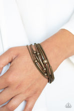 Load image into Gallery viewer, A collection of brass beads and brass accents slides along brass spring-like bracelets, creating stretchy layers around the wrist. Features a magnetic closure.  Sold as one individual bracelet.  Always nickel and lead free.