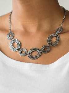 Radiating with circular details, airy oval frames link below the collar for a casual look. Features an adjustable clasp closure.  Sold as one individual necklace. Includes one pair of matching earrings.  Always nickel and lead free.