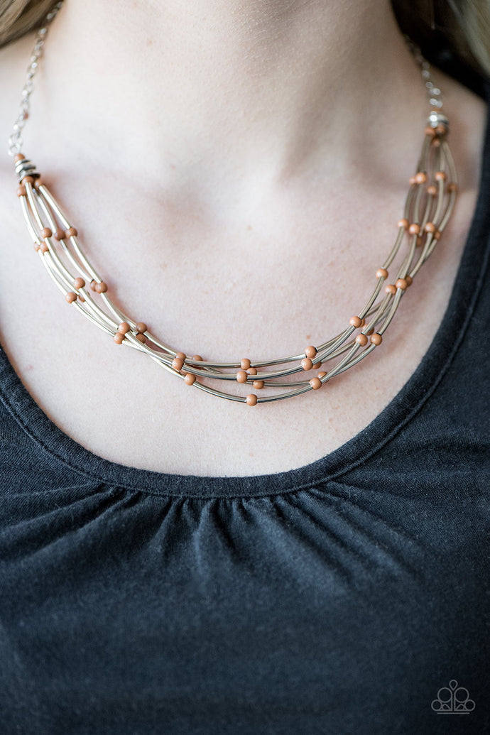 Shimmery silver accents and dainty Butterum beads are threaded along strands of wire, creating colorful layers below the collar. Features an adjustable clasp closure.  Sold as one individual necklace. Includes one pair of matching earrings.   Always nickel and lead free.