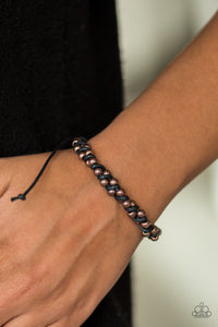 Threaded along shiny black twine, classic copper beads twist around the wrist for an urban look. Features an adjustable sliding knot closure.  Sold as one individual bracelet.  Always nickel and lead free.