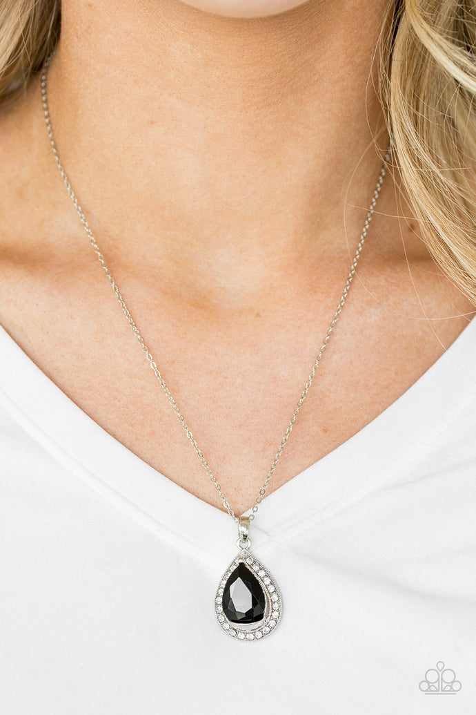 Featuring a regal teardrop cut, a glittery black gem sits atop a silver frame encrusted in glassy white rhinestones. The royal pendant swings below the collar in a glamorous fashion. Features an adjustable clasp closure.  Sold as one individual necklace. Includes one pair of matching earrings.  Always nickel and lead free.