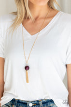 Load image into Gallery viewer, A dramatic pearly purple bead swings from the bottom of an elegantly elongated gold chain. Featuring a hammered fitting, a gold tassel streams from the bottom of the colorful pendant for a refined finish. Features an adjustable clasp closure.  Sold as one individual necklace. Includes one pair of matching earrings.  Always nickel and lead free.
