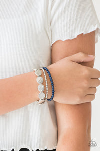 Mismatched silver and Sargasso Sea beads and round silver accents are threaded along stretchy bands, creating colorful layers around the wrist.  Sold as one set of three bracelets.  Always nickel and lead free.