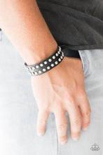 Load image into Gallery viewer, Rows of glistening silver studs are encrusted along the front of a black leather band for a rugged look. Features an adjustable snap closure.  Sold as one individual bracelet.  Always nickel and lead free.