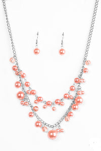 ﻿ Featuring glassy and pearly finishes, dainty coral beads swing from the bottom of layered silver chains, creating a bubbly fringe below the collar. Features an adjustable clasp closure.  Sold as one individual necklace. Includes one pair of matching earrings.