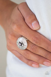 Dotted with a sparkling purple rhinestone, a dainty silver flower blooms atop a rounded frame radiating with shimmery silver texture for a seasonal look. Features a stretchy band for a flexible fit.  Sold as one individual ring.  Always nickel and lead free.