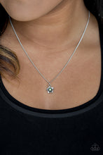 Load image into Gallery viewer, A glittery green rhinestone is pressed into the center of a dainty silver daisy, creating a whimsical pendant below the collar. Features an adjustable clasp closure.  Sold as one individual necklace. Includes one pair of matching earrings.  Always nickel and lead free.
