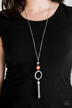 Load image into Gallery viewer, Infused with a lengthened silver chain, a faceted crystal-like bead, an oversized pearly orange bead, and a hammered silver hoop give way to a shimmery silver tassel for a refined look. Features an adjustable clasp closure.  Sold as one individual necklace. Includes one pair of matching earrings.  Always nickel and lead free.