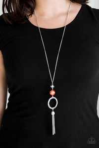 Infused with a lengthened silver chain, a faceted crystal-like bead, an oversized pearly orange bead, and a hammered silver hoop give way to a shimmery silver tassel for a refined look. Features an adjustable clasp closure.  Sold as one individual necklace. Includes one pair of matching earrings.  Always nickel and lead free.