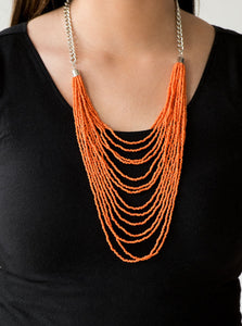 Row after row of vivacious orange seed beads cascade down the chest, creating summery layers. Features an adjustable clasp closure.  Sold as one individual necklace. Includes one pair of matching earrings. 
