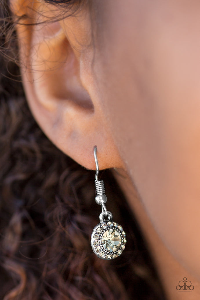 A glittery smoky rhinestone is pressed into a dainty silver frame. Dazzling smoky rhinestones are sprinkled around the beaming center, adding a refined shimmer to the timeless frame. Earring attaches to a standard fishhook fitting.  Sold as one pair of earrings.  Always nickel and lead free.