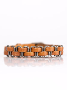 Strands of rustic brown leather are threaded through metallic links, creating an urban look around the wrist. Features a buckle closure.  Sold as one individual bracelet.  
