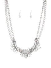 Load image into Gallery viewer, A classic strand of silver pearls and dramatic silvery chain drape below the collar. Infused with heavy metal accents, teardrop and marquise cut white rhinestone frames connect into a show-stopping fringe. Features an adjustable clasp closure.  Sold as one individual necklace. Includes one pair of matching earrings.  