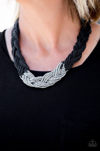 Strands of black seed beads create an indigenous braid below the collar. The black seed beads gradually morph into metallic silver beads at the center for a chic contrasting look. Features an adjustable clasp closure.  Sold as one individual necklace. Includes one pair of matching earrings.  Always nickel and lead free