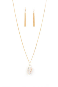 Bordered in a glistening gold finish, an iridescent seashell swings from the bottom of a lengthened gold chain for a summery flair. Features an adjustable clasp closure.  Sold as one individual necklace. Includes one pair of matching earrings.