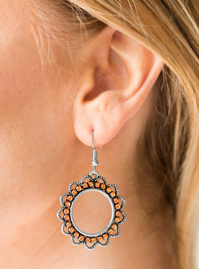 Textured silver petals flare from an orange rhinestone encrusted ring, creating a whimsical lure. Earring attaches to a standard fishhook fitting.  Sold as one pair of earrings. 
