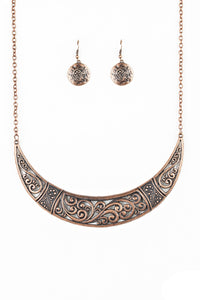 Swirling with ornate filigree filled detail, a shimmery copper crescent plate swings below the collar for a fierce look. Features an adjustable clasp closure.  Sold as one individual necklace. Includes one pair of matching earrings. 