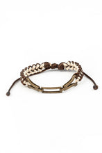 Load image into Gallery viewer, Braided strands of brown and white twine-like cording knot around interlocking brass frames, creating an edgy urban centerpiece around the wrist. Features an adjustable sliding knot closure.  Sold as one individual bracelet.