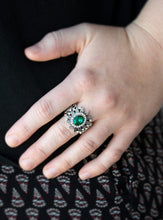 Load image into Gallery viewer, Ringed in glittery white rhinestones, a sparkling green gem is pressed into the center of a leafy silver frame. Dainty white rhinestones are sprinkled along the shimmery foliage for a refined finish. Features a stretchy band for a flexible fit.  Sold as one individual ring.   