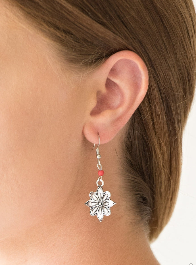 Brushed in a high-sheen finish, a glistening silver flower frame swings from the bottom of a dainty red stone for a seasonal look. Earring attaches to a standard fishhook fitting.  Sold as one pair of earrings.
