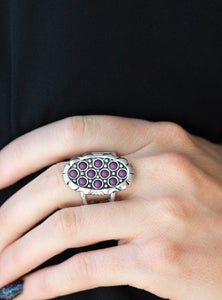 Dainty purple stones are sprinkled across the front of a studded silver frame, creating a vivacious centerpiece atop the finger. Features a stretchy band for a flexible fit.  Sold as one individual ring.  