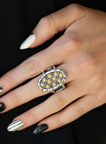 Dainty yellow stones are sprinkled across the front of a studded silver frame, creating a refreshing centerpiece atop the finger. Features a stretchy band for a flexible fit.  Sold as one individual ring.