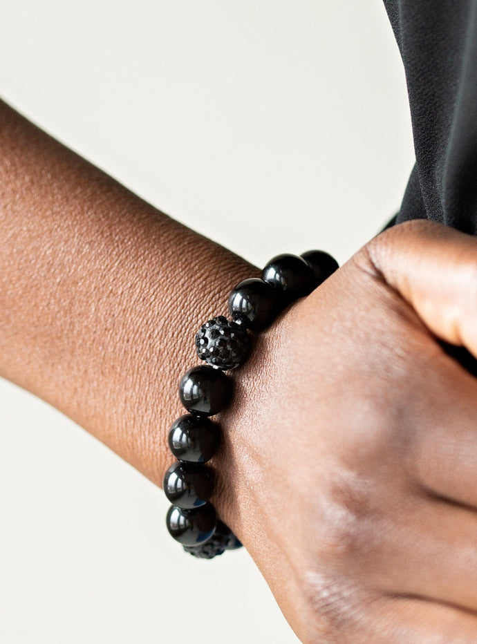 A collection of shiny black beads and black rhinestone encrusted beads are threaded along a stretchy band around the wrist for a refined flair.  Sold as one individual bracelet.  P9RE-BKXX-227XX  
