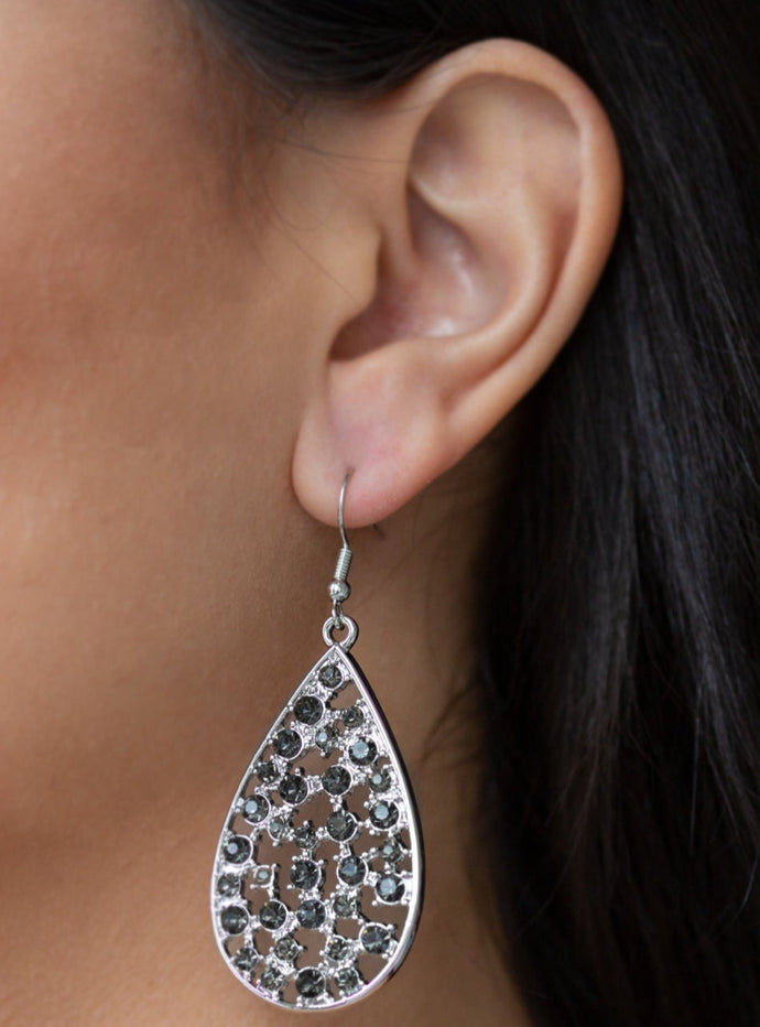 Hints of silver frames and smoky rhinestones collect inside an airy silver teardrop, creating a gorgeous lure. Earring attaches to a standard fishhook fitting.  Sold as one pair of earrings. 