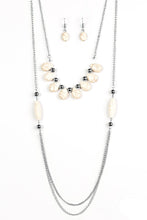Load image into Gallery viewer, Chiseled into smooth teardrops, earthy white stones and classic silver beads are threaded along a skinny wire, creating an earthy fringe. Complimented with matching beads, cylindrical white stones give way to rows of silver chain for a bold layered finish. Features an adjustable clasp closure.  Sold as one individual necklace. Includes one pair of matching earrings.