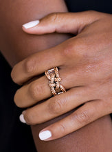 Load image into Gallery viewer, Encrusted in glittery rhinestones, shimmery copper bars crisscross across the finger, coalescing into a bold square knot atop the finger. Features a stretchy band for a flexible fit.  Sold as one individual ring.