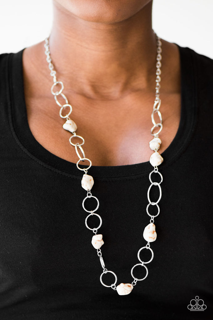 Earthy white stone beading trickles along shimmery silver hoops, creating a colorfully earthy palette. Features an adjustable clasp closure.  Sold as one individual necklace. Includes one pair of matching earrings.  Always nickel and lead free.