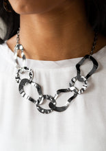 Load image into Gallery viewer, Brushed in a high-sheen finish, warped gunmetal links connect below the collar for an edgy statement. Features an adjustable clasp closure.  Sold as one individual necklace. Includes one pair of matching earrings.  