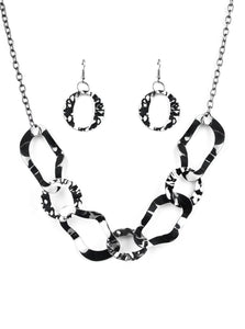 Brushed in a high-sheen finish, warped gunmetal links connect below the collar for an edgy statement. Features an adjustable clasp closure.  Sold as one individual necklace. Includes one pair of matching earrings.  