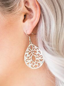 Dainty white beads are sprinkled along a stenciled silver teardrop, creating a whimsical lure. Earring attaches to a standard fishhook fitting.  Sold as one pair of earrings.  