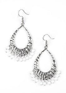 Refreshing white beading swings from the bottom of a delicately hammered silver teardrop, creating a colorful fringe. Earring attaches to a standard fishhook fitting.  Sold as one pair of earrings.