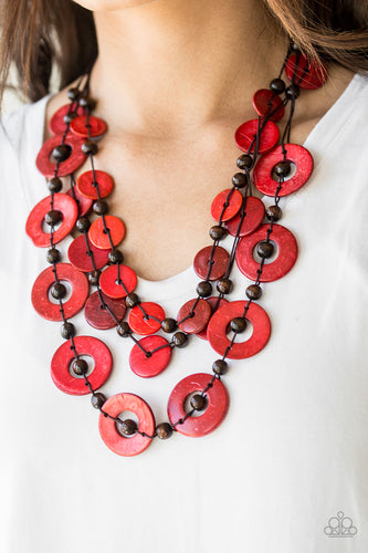 Brushed in a shell-like iridescence, fiery red wooden discs and round brown wooden beads are knotted along three strands of brown cording for a summery look. Features a button loop closure.  Sold as one individual necklace. Includes one pair of matching earrings.  Always nickel and lead free.