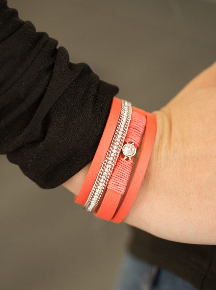 Coral leather strands layer across the wrist. Infused with silver chain and white rhinestone accents, coral cording knots around a leather strand, securing a solitaire white rhinestone in place for a whimsical finish. Features an adjustable clasp closure.  Sold as one individual bracelet.