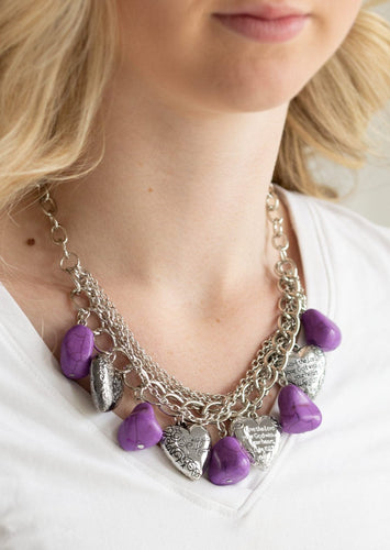 Purple faux rocks alternate with heart charms along a chunky silver chain. Hearts are inscribed with the phrase 