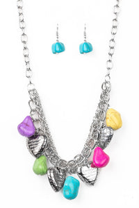 Multicolored faux rocks alternate with heart charms along a chunky silver chain. Hearts are inscribed with the phrase "With All My Heart" on one side and a short bible verse on the other that reads, "Love the Lord thy God with all your heart. Luke 10:27." Layers of various chains add some edge. Features an adjustable clasp closure. Sold as one individual necklace. Includes one pair of matching earrings.