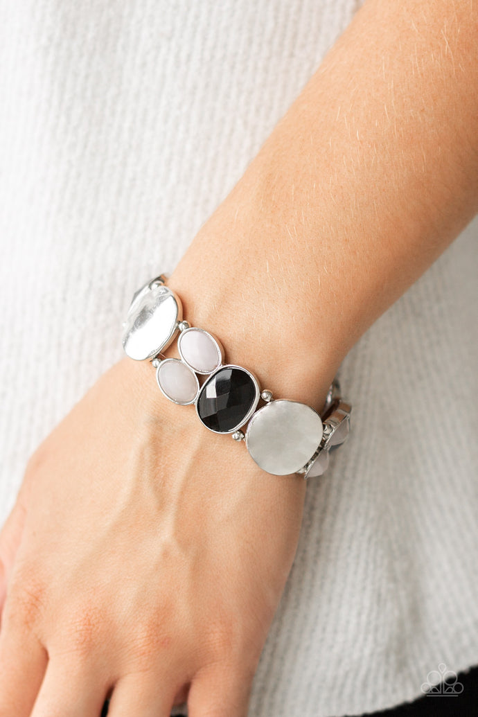A mismatched collection of hammered silver pieces and faceted cloudy, black, and Paloma beads are threaded along a stretchy band around the wrist for a dramatically colorful look.  Sold as one individual bracelet. Always nickel and lead free.