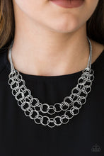 Load image into Gallery viewer, Necklace and Earrings:  Varying in size, rows of shiny silver rings interlock into two layered rows below the collar for an edgy industrial look. Features an adjustable clasp closure.  Bracelet:  Varying in size, rows of shiny silver rings interlock across the wrist for a bold industrial look. Features an adjustable clasp closure.