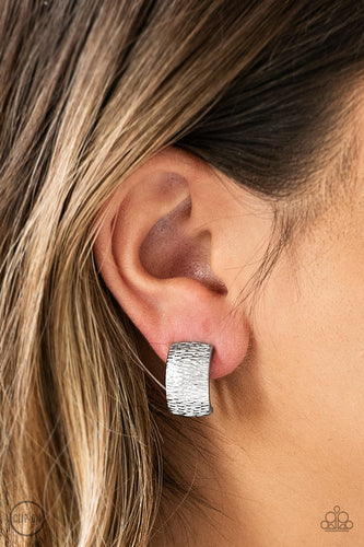 Rippling with tactile textures, a shimmery silver ribbon curls into an edgy frame for a causal look. Earring attaches to a standard clip-on fitting.  Sold as one pair of clip-on earrings.   Always nickel and lead free. 