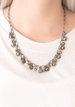 Load image into Gallery viewer, Faceted gunmetal beads and glittery hematite rhinestone encrusted frames swing from the bottom of a bold gunmetal chain, creating a sassy fringe below the collar. Features an adjustable clasp closure.  Sold as one individual necklace. Includes one pair of matching earrings.