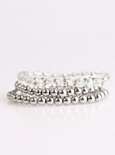 Load image into Gallery viewer, Classic silver beads and faceted white beading are threaded along three stretchy bands, creating refined layers across the wrist in a sleek fashion.  Sold as one set of three bracelets.