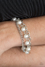 Load image into Gallery viewer, A classic strand of white pearls joins two mismatched silver chains around the wrist for a refined look. Features an adjustable clasp closure.  Sold as one individual bracelet.