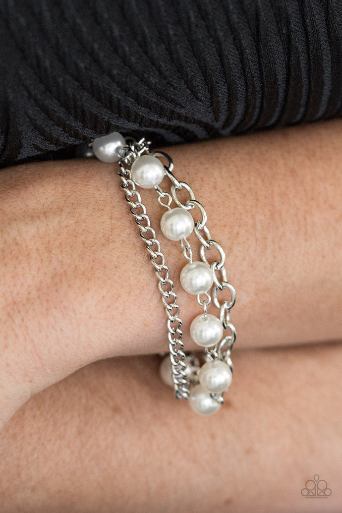 A classic strand of white pearls joins two mismatched silver chains around the wrist for a refined look. Features an adjustable clasp closure.  Sold as one individual bracelet.