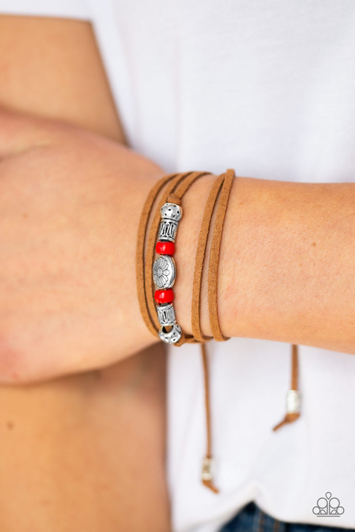 An array of red and silver beads are knotted in place along elongated suede cording for a wanderlust fashion. To secure bracelet, tie ends in place around the wrist at desired length.  Sold as one individual bracelet.  Always nickel and lead free.