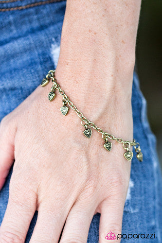 Brushed in an antiqued shimmer, dainty brass hearts trickle from the wrist in a romantic fashion.  Features and adjustable clasp closure.  Sold as one individual bracelet.   Always nickel and lead free.   